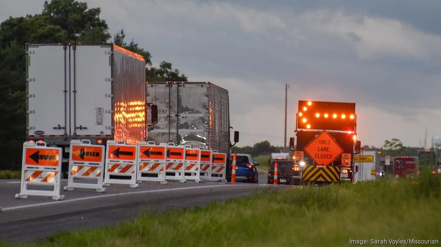 Stock photo of semis and other vehicles going through road construction